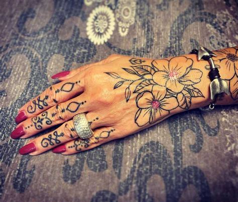 flowers tattoo hand|flower hand tattoos for women.